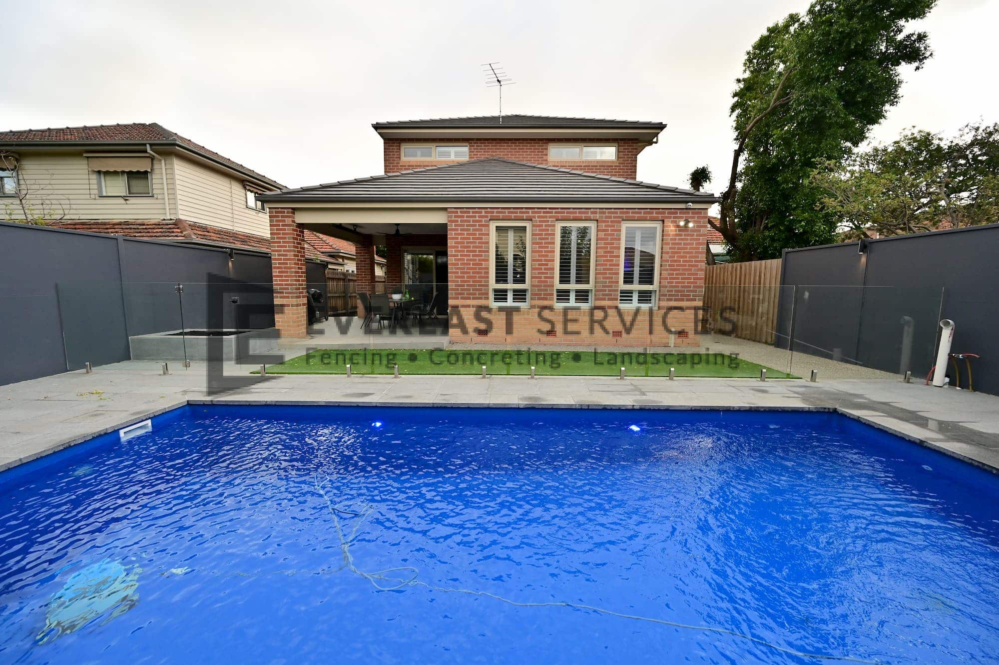 L284 - Yarraville - Backyard Landscaping with Glass Pool Fence looking directly at the house
